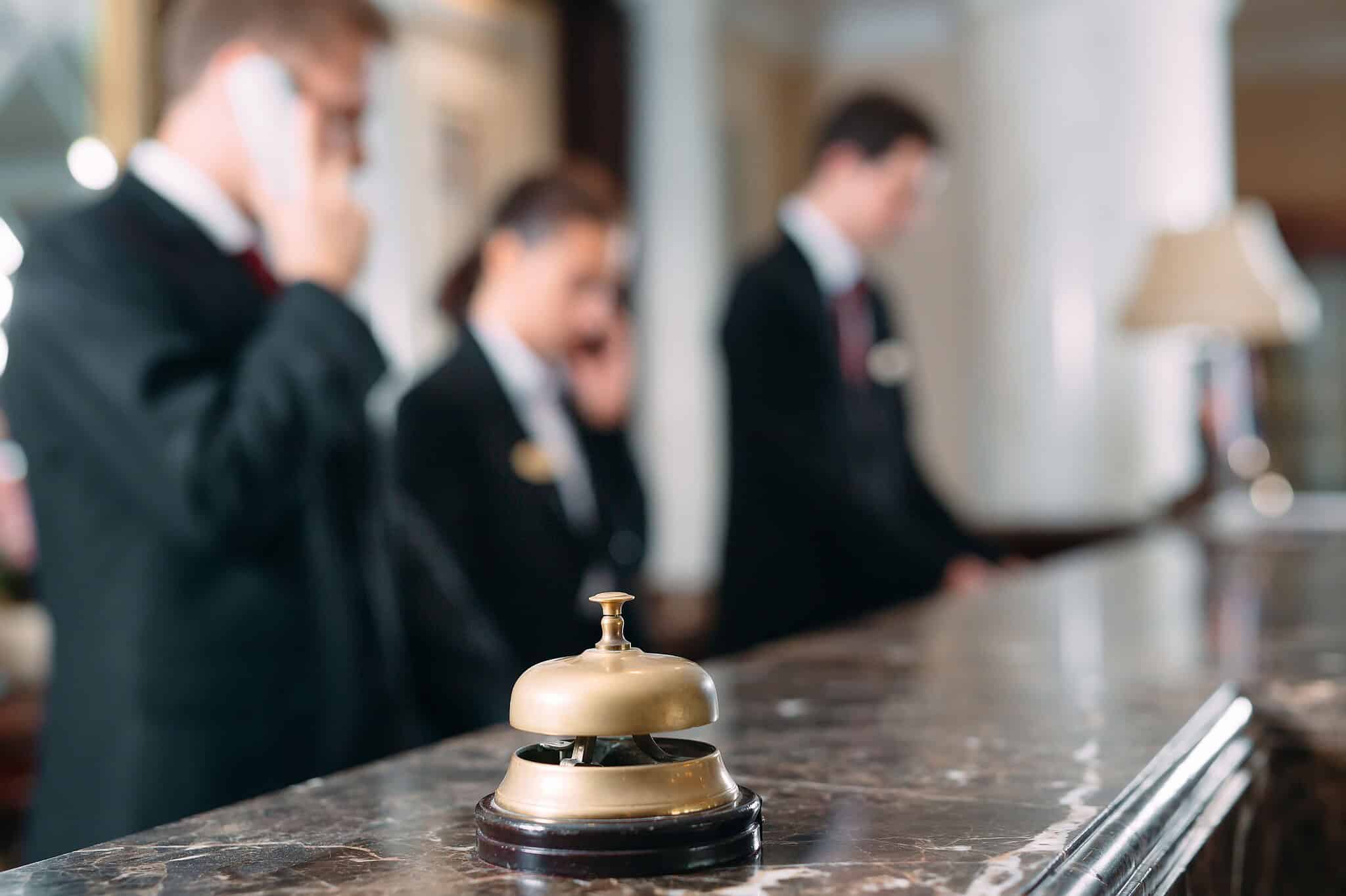 Hotel reception desk with bell and staff in background, Meridian Integrated Systems.