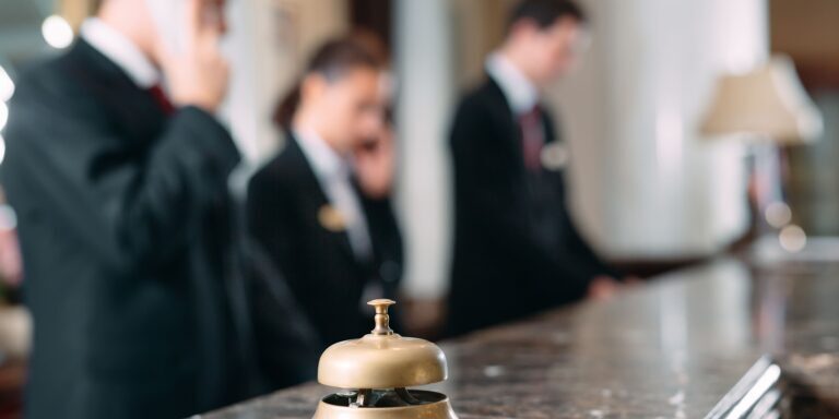 Hotel reception desk with bell and staff in background, Meridian Integrated Systems.